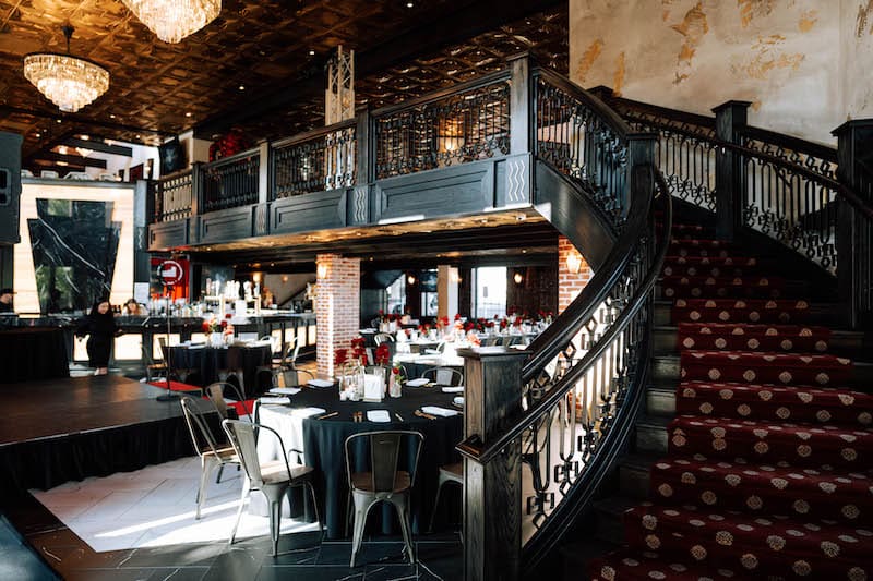 Private club venue with a grand staircase set for an evening celebration