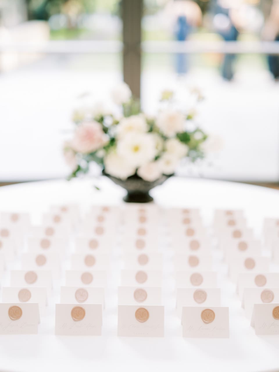 Reception table detail with a low centerpiece and place settings